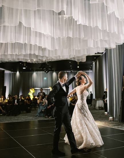 Wedding couple dancing under white drapery at Elevate at One Campus Martius.