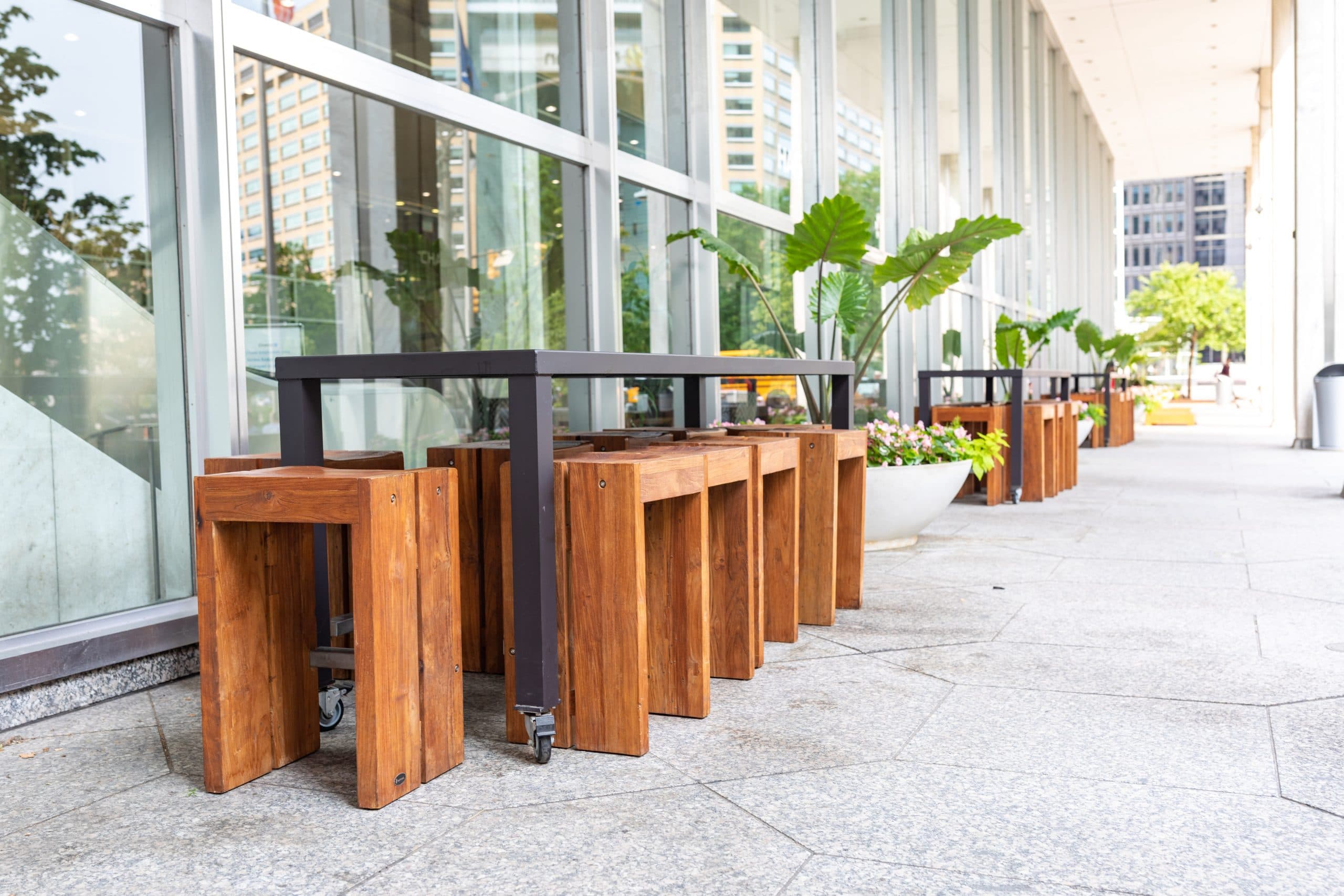 Chase Tower Lobby + Patio featuring a large live planter, and outdoor patio furniture and revolving doors to the indoor lobby space.