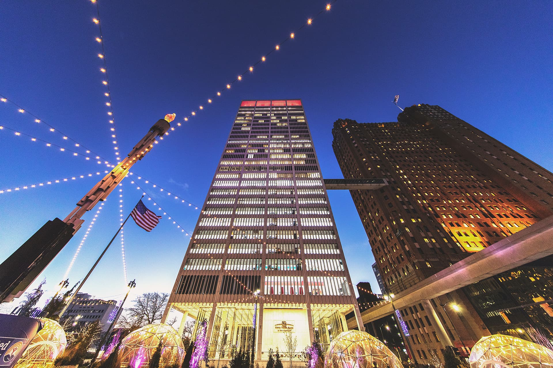 Exterior view of the One Woodward building from Spirit Plaza with skybridge to The Guardian building and People Mover track.
